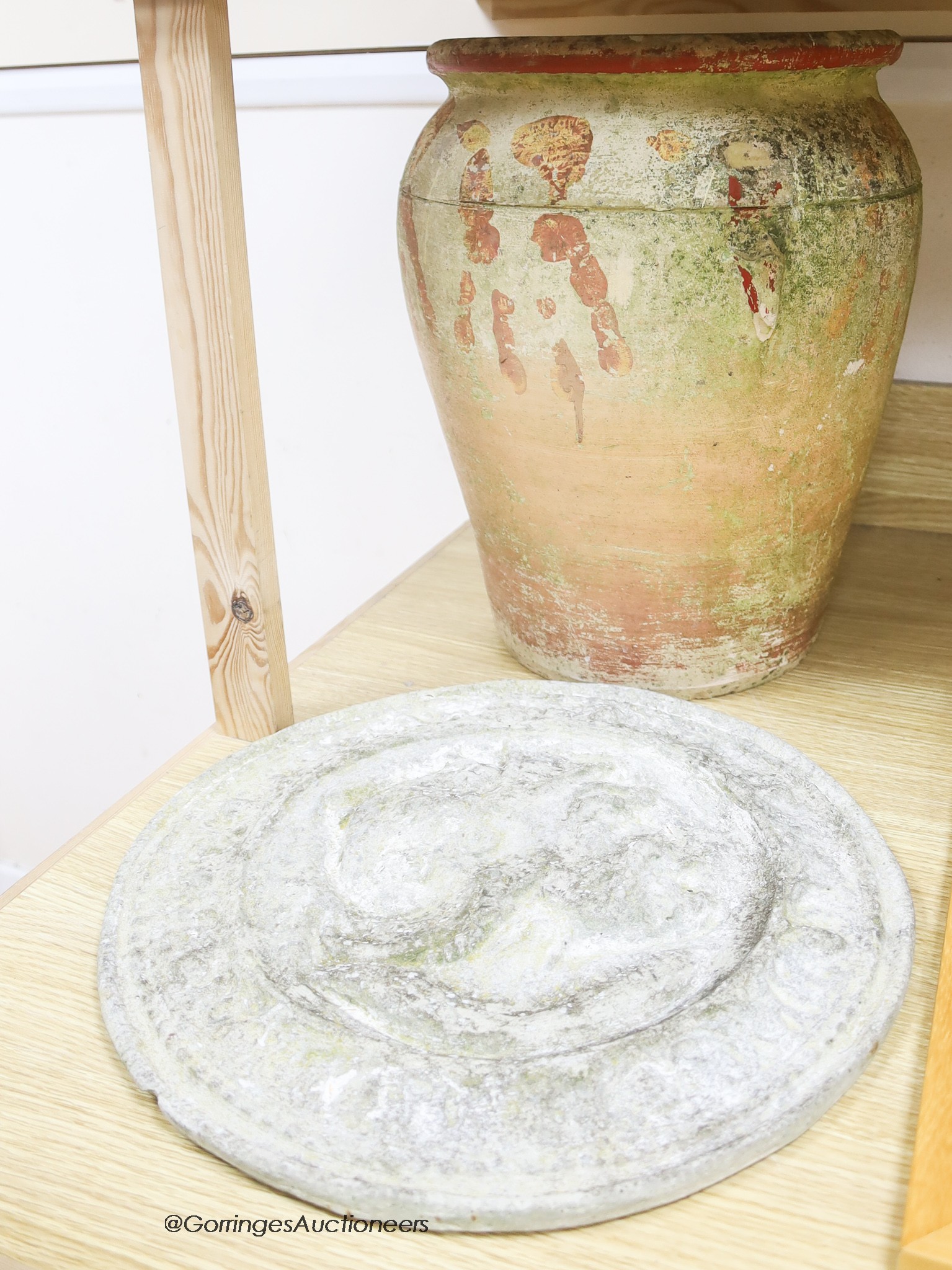 A Roman-style terracotta pot, height 40cm, and a Roman headed cartouche